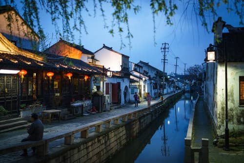 Lantern-lit canal and traditional houses along Pingjiang Road in Suzhou
